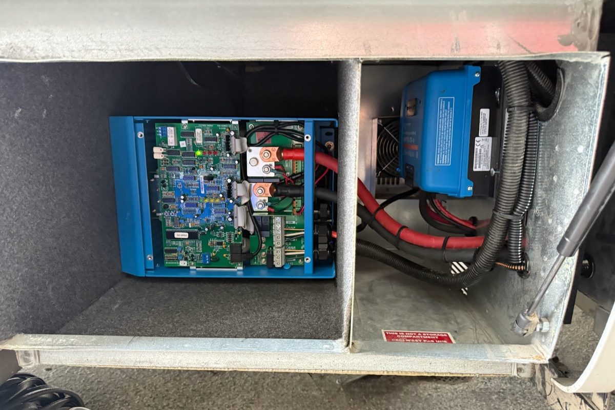 Victron inverter/charger and DC-DC charger mounted in an RV service bay compartment at Stream RV