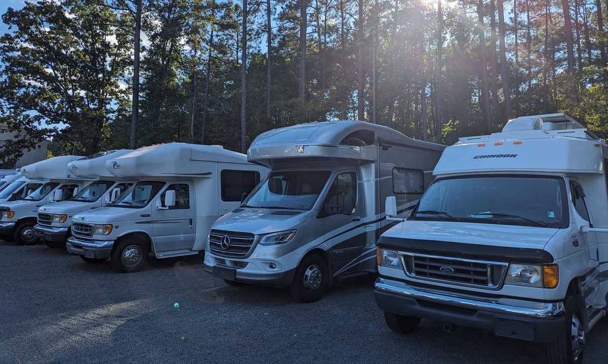 Class B and Class C motorhomes lined up under the pines at Stream RV in Creedmoor, NC